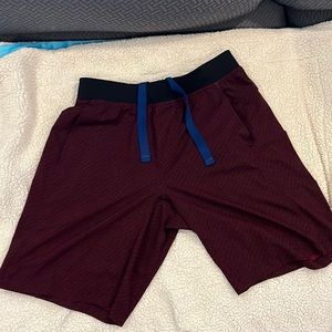 Men’s Lululemon Size Large 11” inseam Linerless Shorts. Color is a red/black.